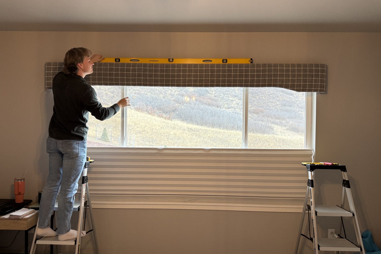 Mitch leveling a custom cornice over a window in a Monument, Colorado home